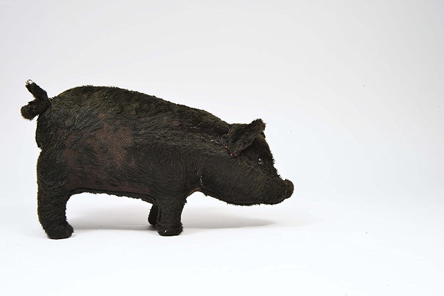 Appraisal: AN OLD BLACK PLUSH STRAW FILLED TOY of a pig