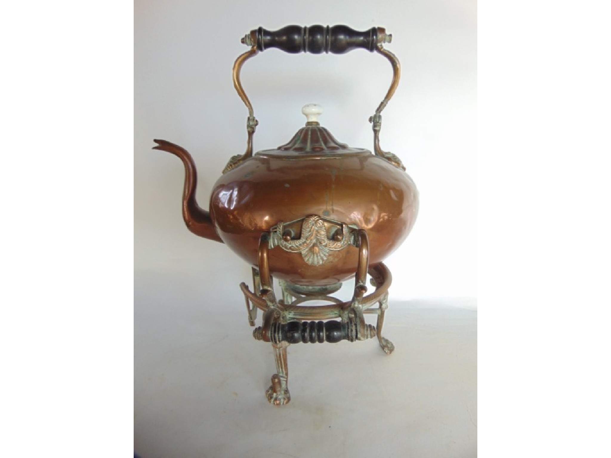 Appraisal: A heavy antique copper kettle raised on associated stand with