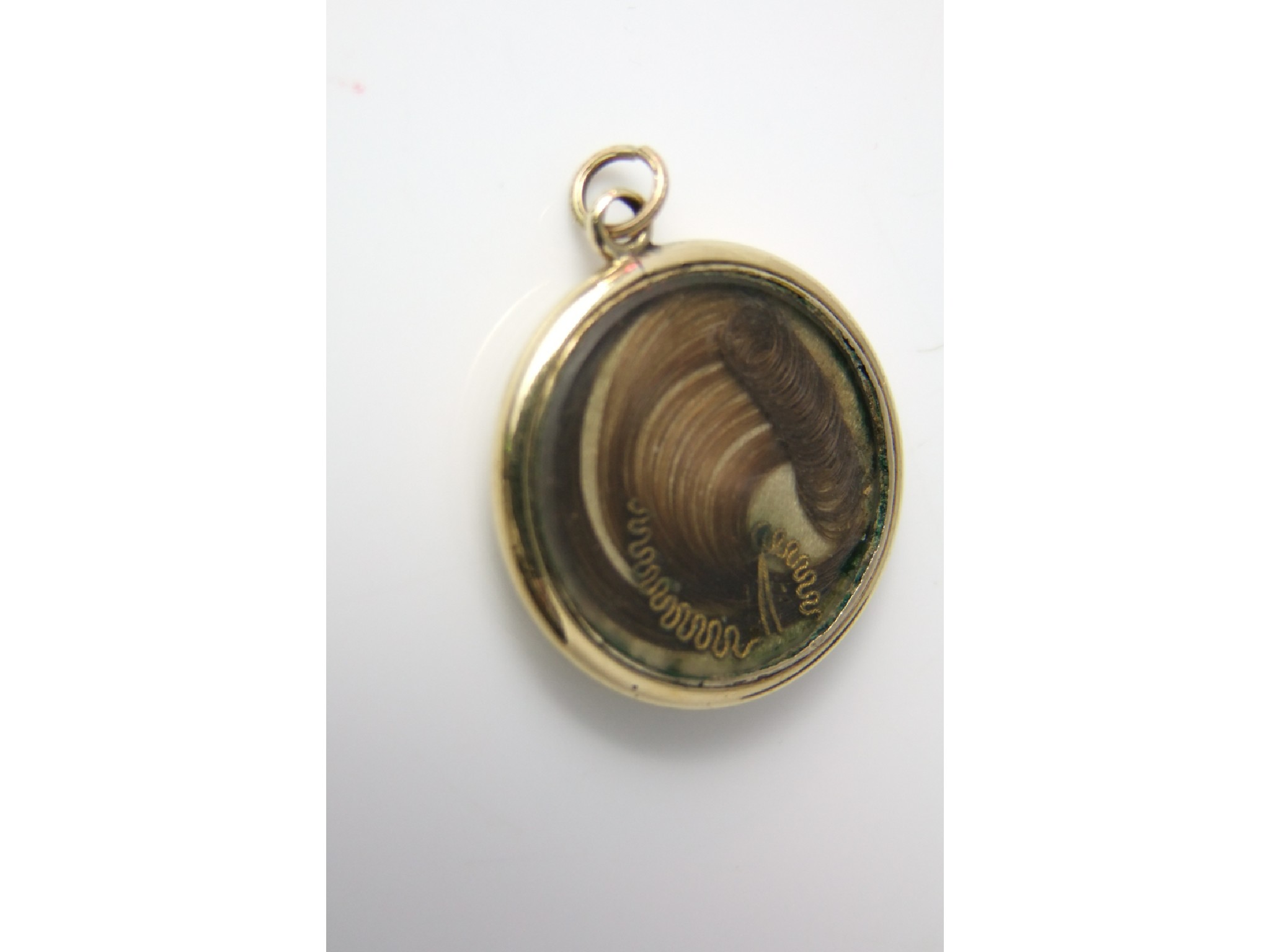 Appraisal: A Victorian mourning locket inset with a flowing hair bouquet