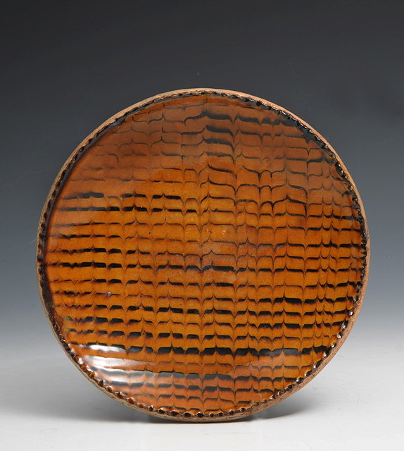 Appraisal: Leach Pottery probably Bernard LeachDish mid late sfeathered slip decorationimpressed