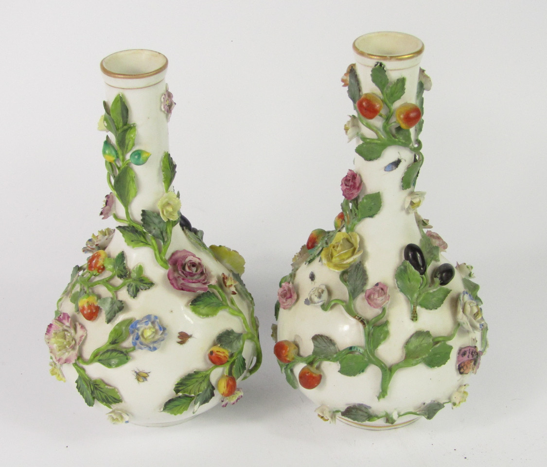 Appraisal: A pair of thC porcelain bottle vases encrusted and painted