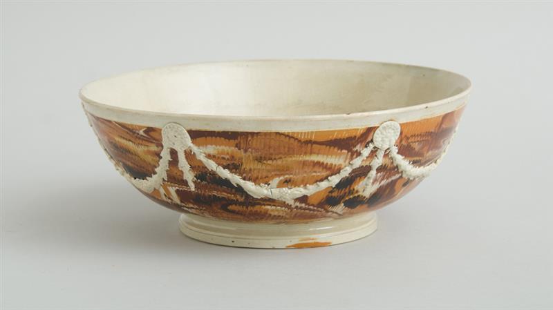 Appraisal: ENGLISH MOCHAWARE BOWL With feathered ground with relief molded and