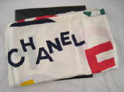 Appraisal: A Chanel scarf with CHANEL in bright colours in random