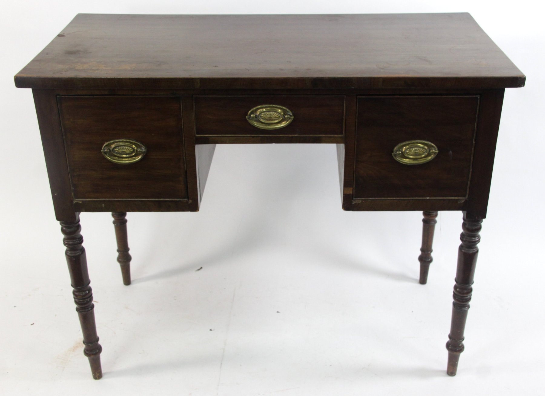 Appraisal: A Victorian mahogany kneehole table fitted three drawers on turned