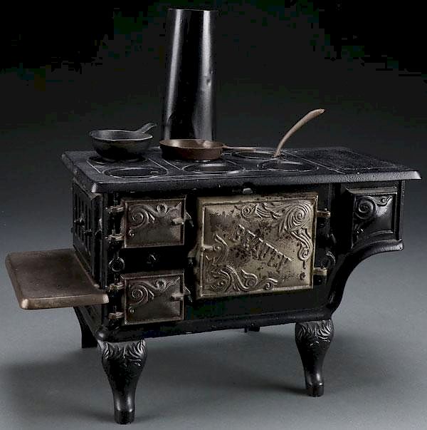 Appraisal: A CHILD'S CAST IRON TOY BEAUTY COOK STOVE A CHILD'S