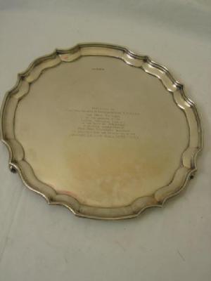 Appraisal: A PRESENTATION SALVER of circular form with moulded Chippendale border