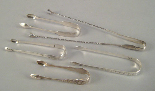 Appraisal: Four coin silver tongs th c together with olive tongs