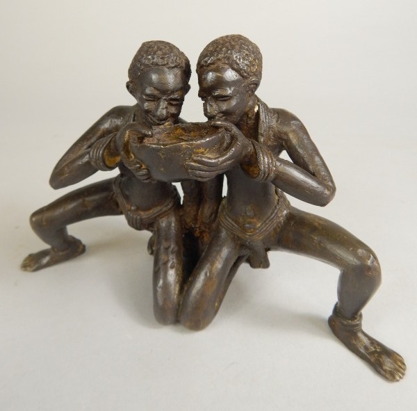 Appraisal: Tribal Art An African bronze group of two people drinking