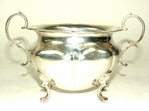 Appraisal: An Edwardian silver sugar bowl with wavy border and twin