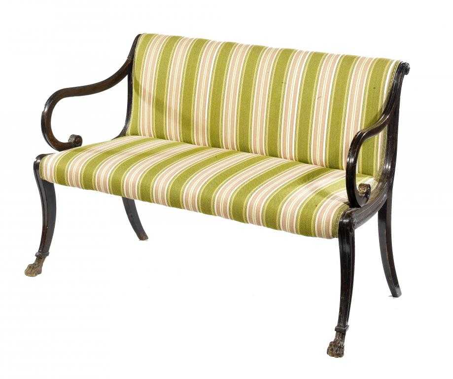 Appraisal: A MAHOGANY SETTEE the channelled frame with scrolling arms on