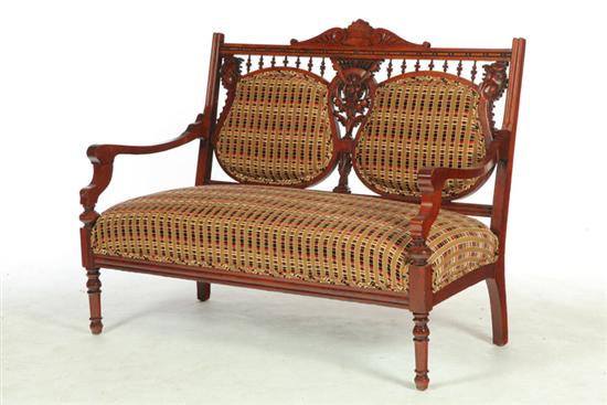 Appraisal: EASTLAKE VICTORIAN LOVESEAT American or English th century cherry Turned