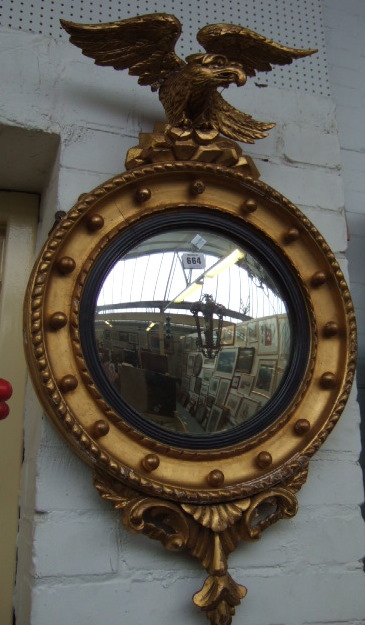 Appraisal: A Regency design gilt framed wall mirror the eagle crest