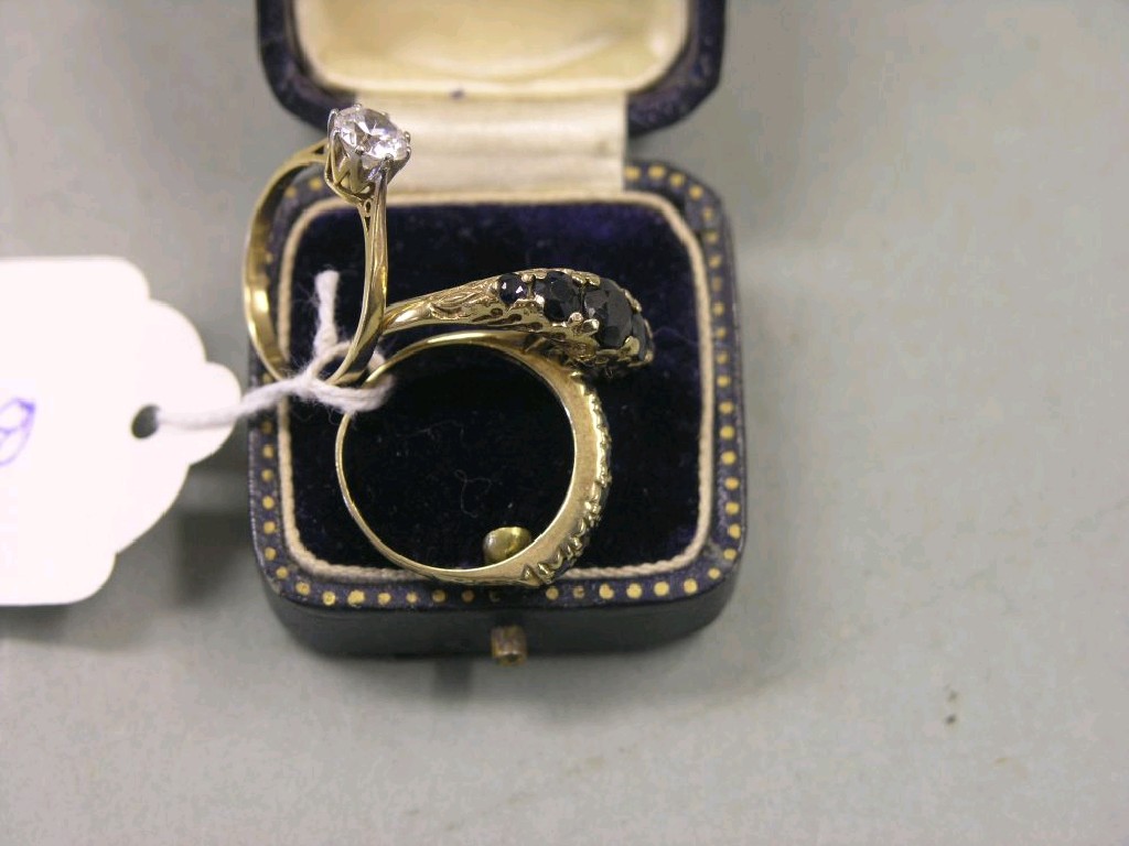 Appraisal: A ct gold half-hoop ring set seven dark stones a