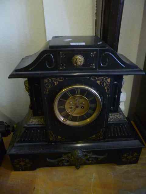 Appraisal: A VICTORIAN BLACK SLATE MANTEL CLOCK with applied brass mask