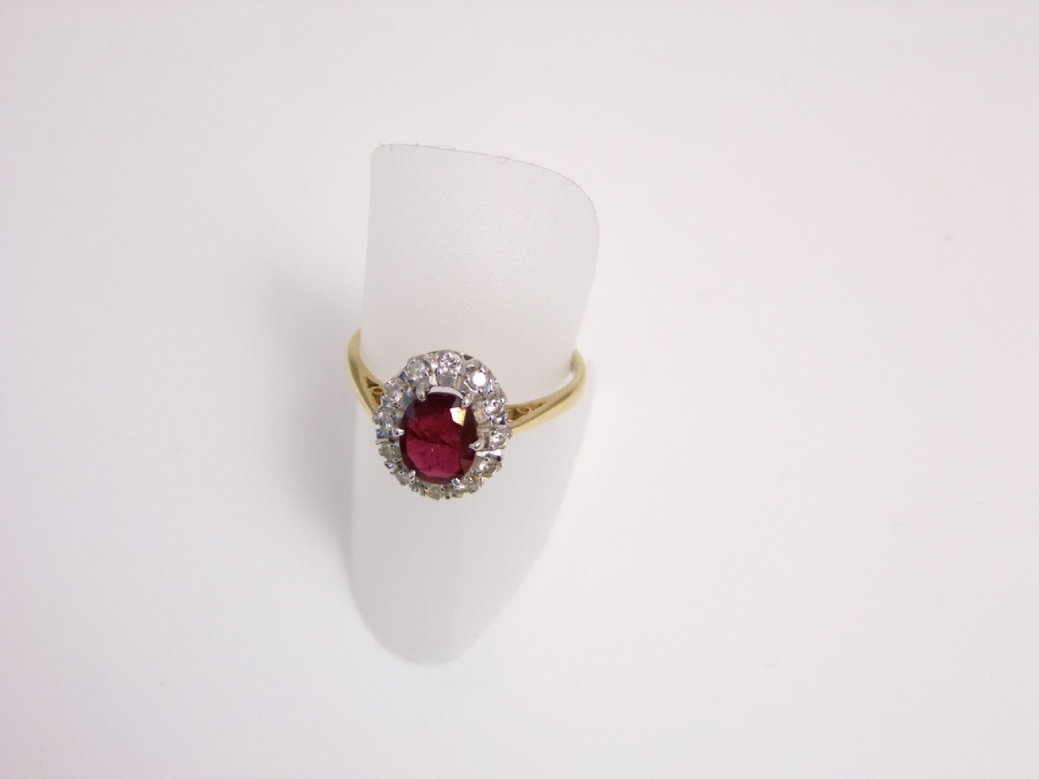 Appraisal: A ruby and diamond ring centred with an oval mixed-cut