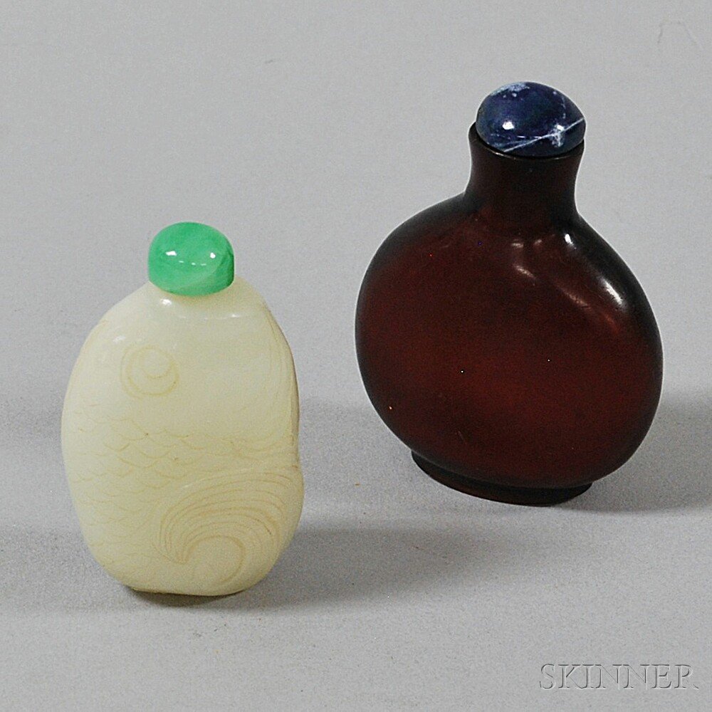 Appraisal: Two Glass Snuff Bottles a pebble-shape red bottle with blue