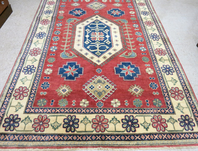 Appraisal: HAND KNOTTED ORIENTAL AREA RUG Pakistani-Caucasian geometric and stylized flower