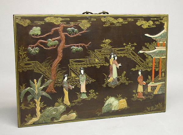 Appraisal: A small soapstone and ivory embellished lacquered wood panel th