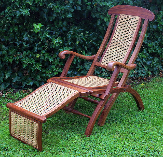 Appraisal: A MODERN TEAK STEAMER CHAIR with caned back seat and