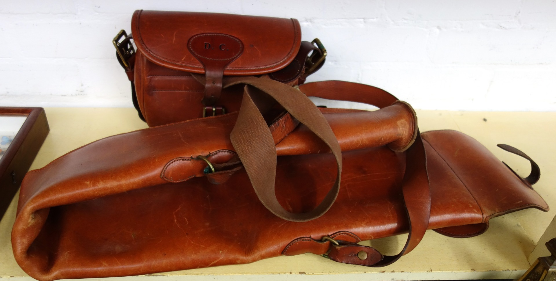 Appraisal: A leather and sheepskin lined gun slip monogrammed 'D C