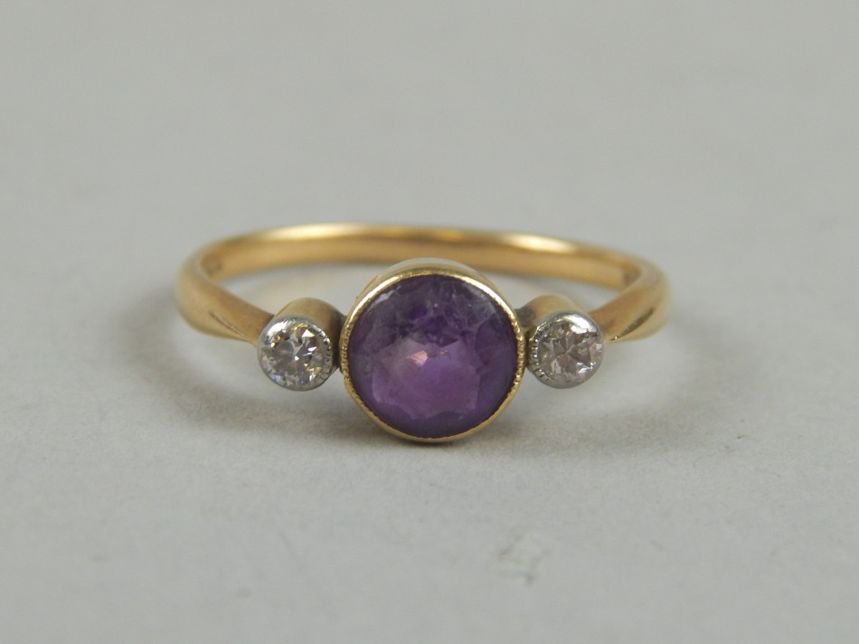 Appraisal: A diamond and amethyst dress ring with central amethyst flanked