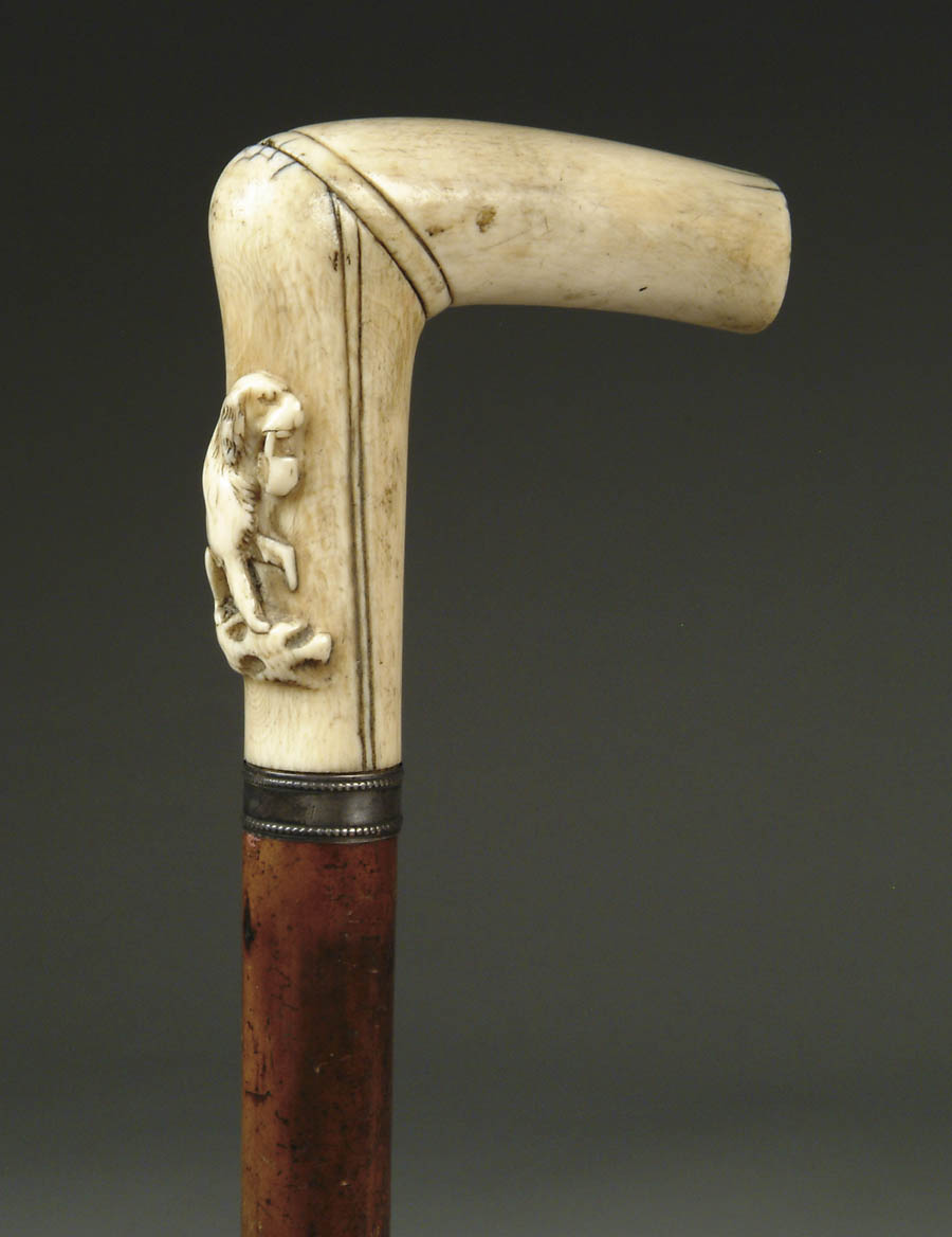 Appraisal: ANTIQUE CARVED IVORY DOG CANE L-shaped ivory handle made in