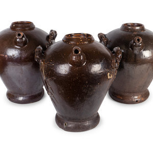 Appraisal: Three Chinese Brown-Glazed Pottery Water Jugs Height x diameter inches