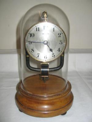 Appraisal: A BOULLE ELECTRIC CLOCK with silvered dial on circular mahogany