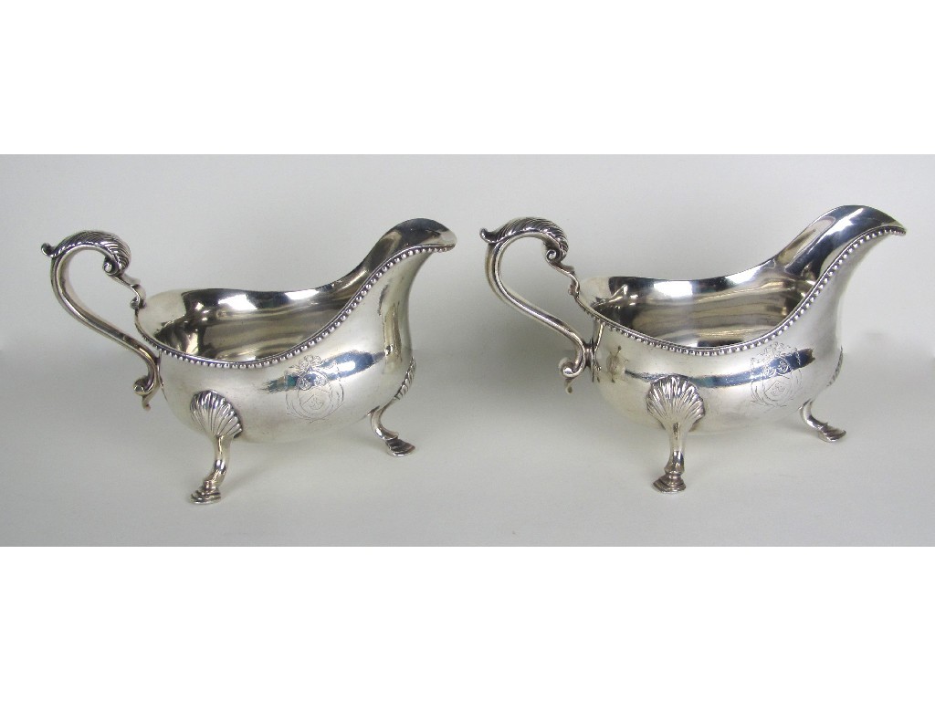 Appraisal: A pair of George III silver sauceboats with armorials beneath