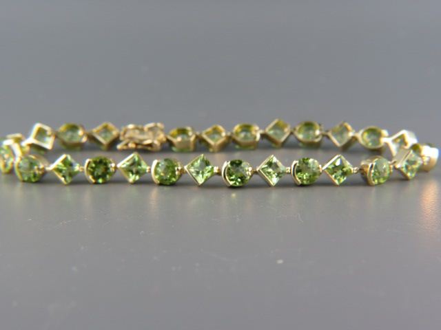 Appraisal: Peridot Bracelet vivid gems round radiant square cuts weighing over