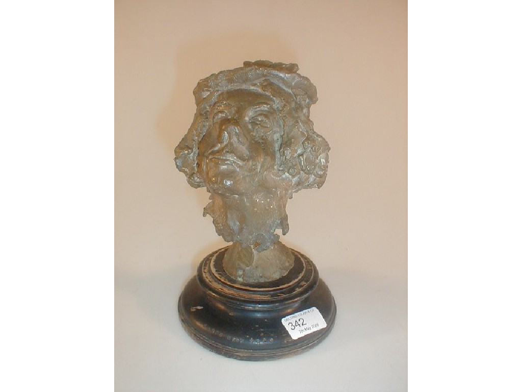 Appraisal: A Bronze mask on a turned ebonised socle stamped HARPO