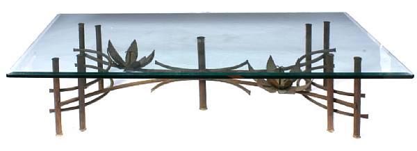 Appraisal: A patinated metal and tole coffee table with bevelled glass