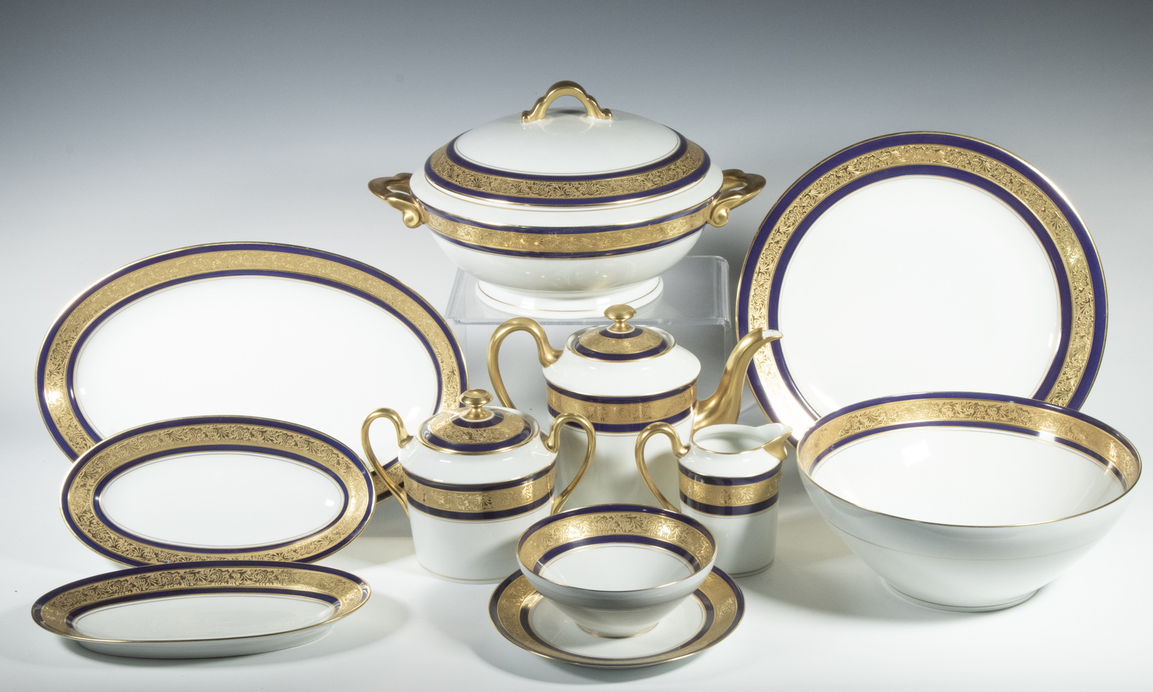 Appraisal: LIMOGES DOUBLE GILDED COBALT BANDED PORCELAIN SET Pieces of Fine