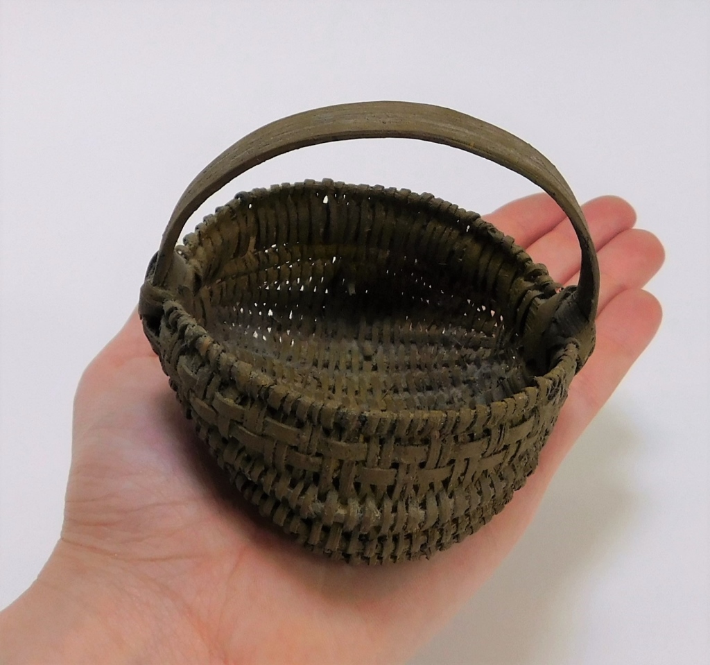 Appraisal: MINIATURE HAND WOVEN YELLOW PIGMENT BUTTOCK BASKET United States th