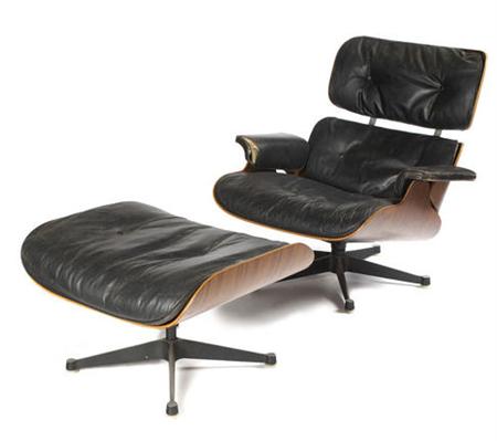 Appraisal: A Charles and Ray Eames armchair and ottoman rosewood ply