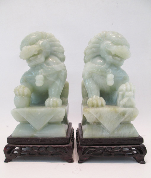 Appraisal: PAIR OF CARVED HARDSTONE FOO DOGS with conforming wood stands