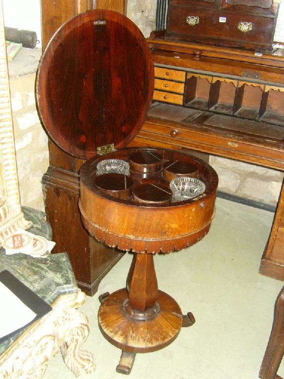 Appraisal: A late Regency period rosewood teapoy the circular lid enclosing