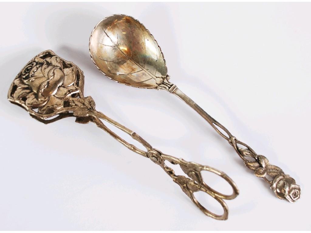 Appraisal: CONTINENTAL SILVER COLOURED METAL STANDARD SPOON with leaf engraved bowl