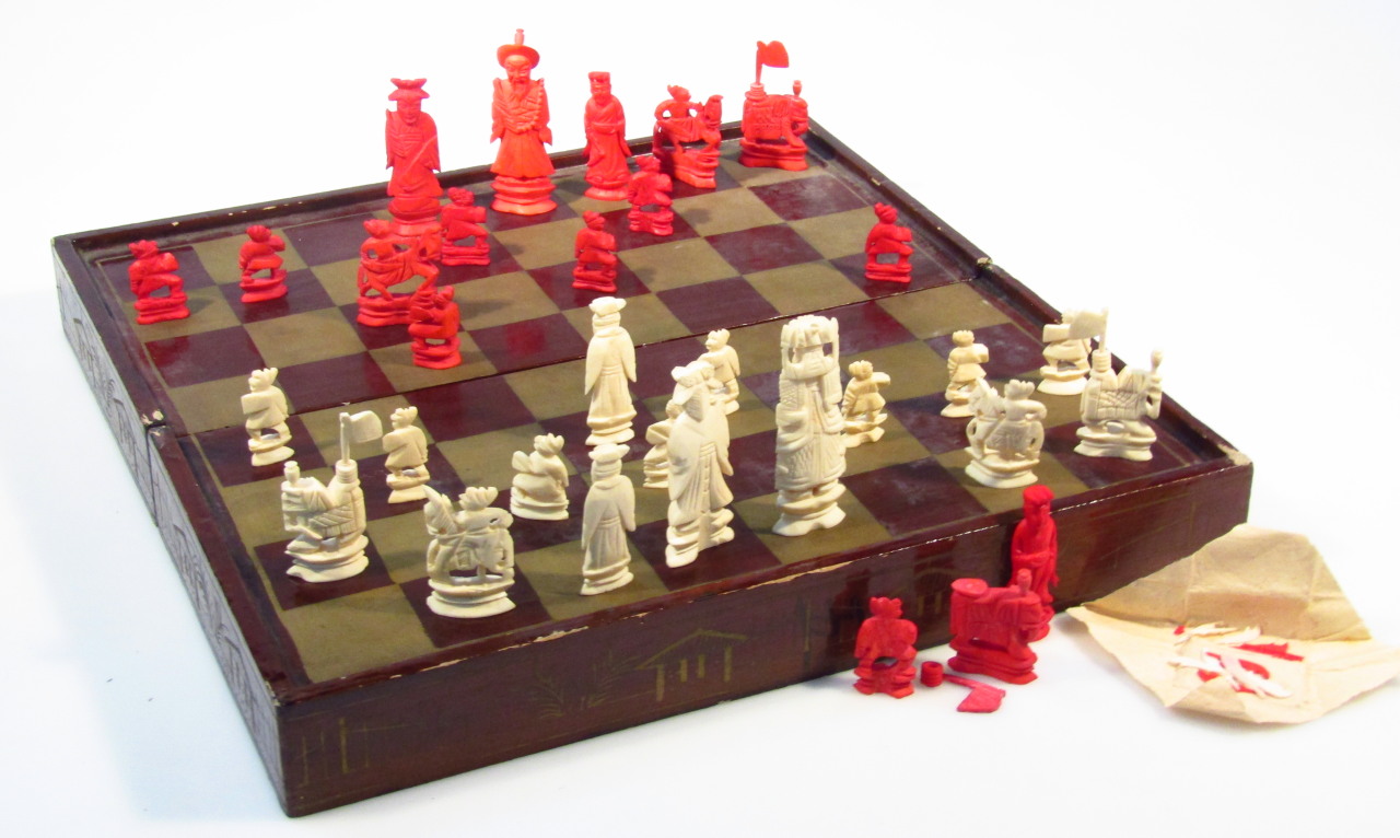 Appraisal: A thC lacquered chess box containing a number of carved