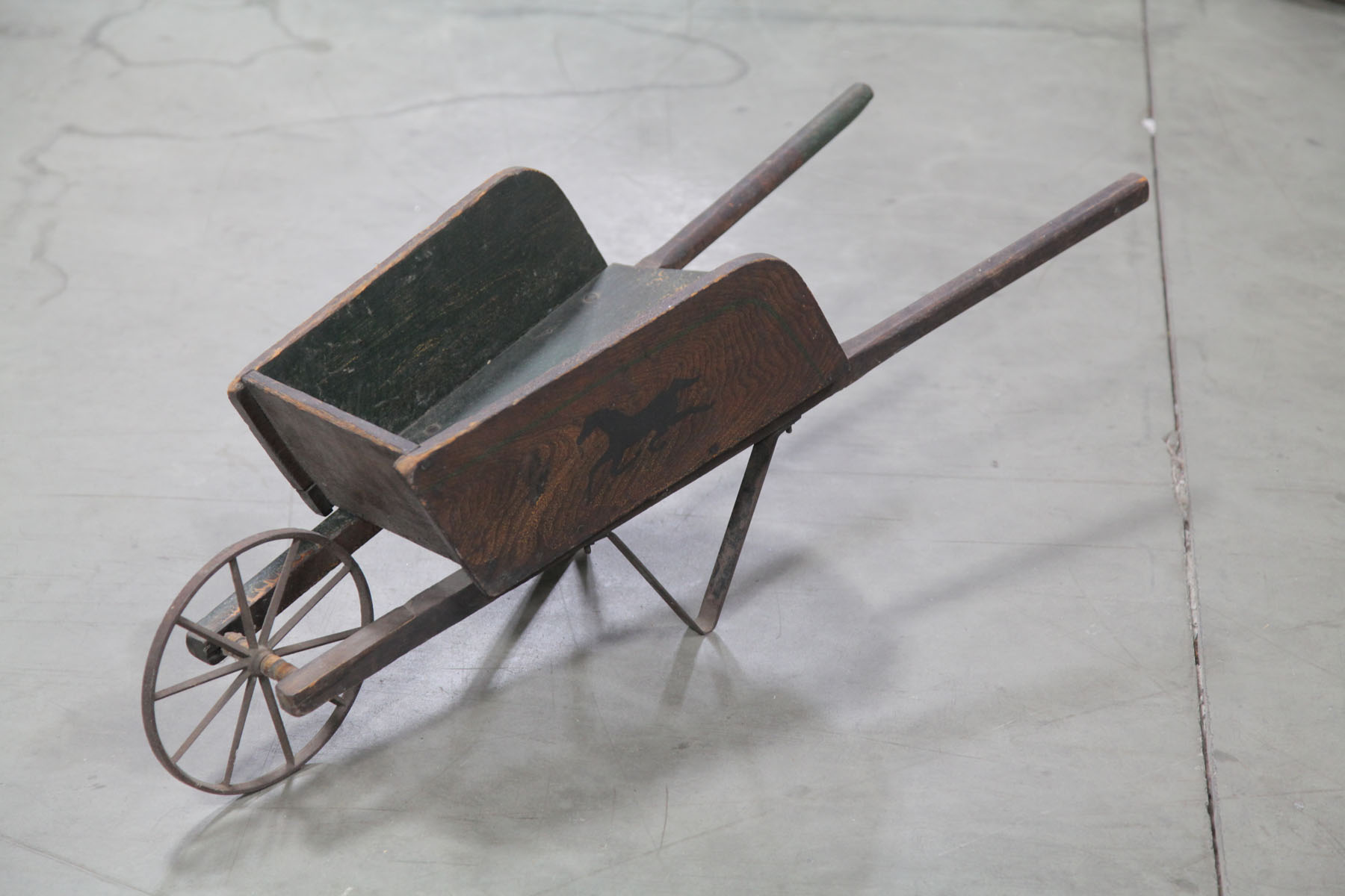 Appraisal: CHILD'S WHEEL BARROW American early th century Green painted wooden