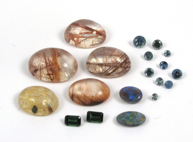 Appraisal: NINETEEN UNSET GEMSTONES including five oval rutilated quarts cabochons weighing