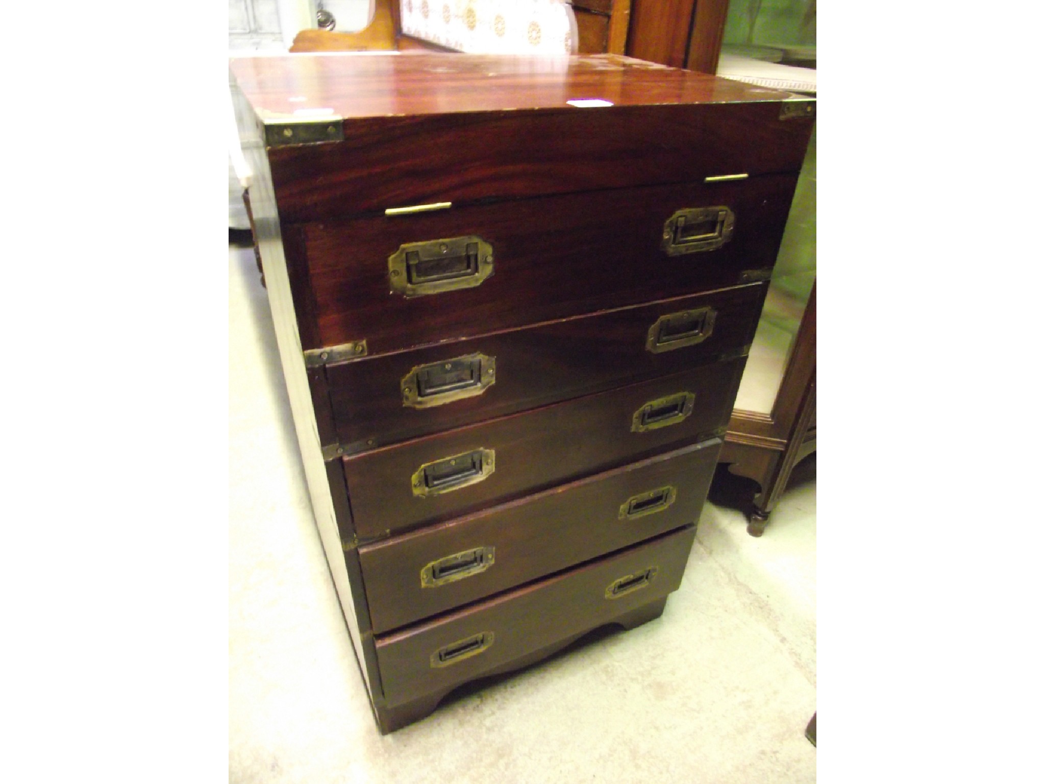 Appraisal: A small mahogany chest in the campaign military style fitted