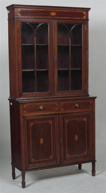 Appraisal: An Edwardian mahogany and marquetry bookcase cabinet of slender form