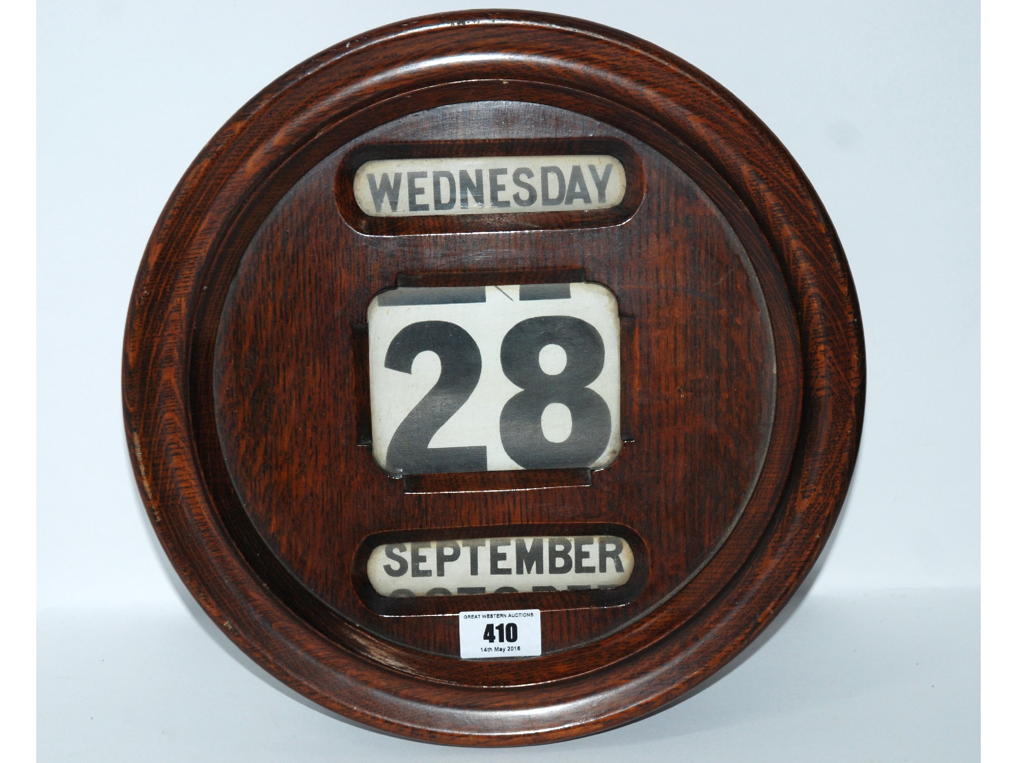 Appraisal: An oak circular wall calendar