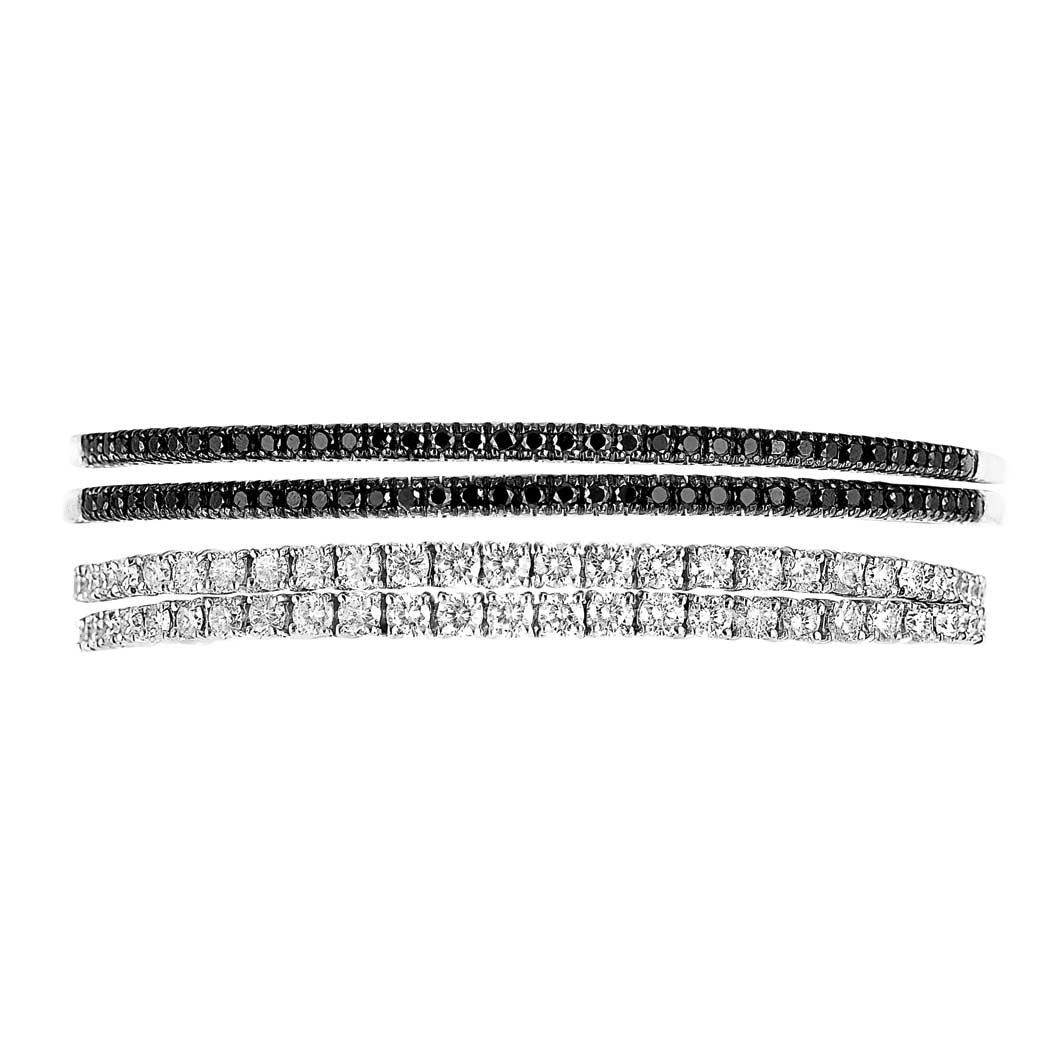 Appraisal: Four White Gold Diamond and Black Diamond Bangle Bracelets kt