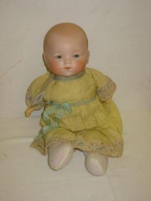 Appraisal: An Armand Marseille bisque head baby doll with blue sleeping