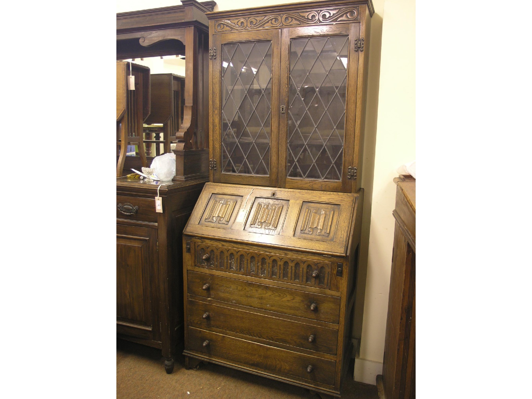 Appraisal: A Jacobean-style medium oak bureau bookcase pair of leaded glazed