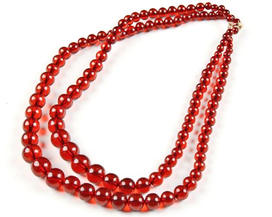 Appraisal: A Cherry Amber Double Strand Bead Necklace the beads graduated