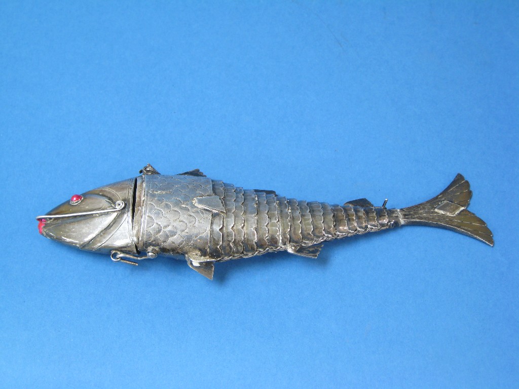 Appraisal: A Continental silver articulated Fish with hinged head inset red