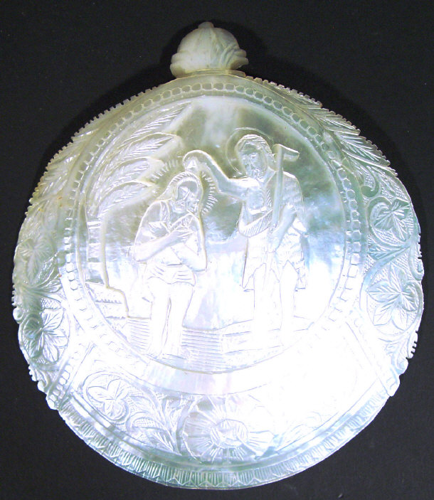 Appraisal: Mother of pearl shell carved in relief with a religious